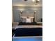 Bedroom featuring a unique accent wall, plush bedding, and stylish lighting at 5526 Stoneleigh Ct, Stone Mountain, GA 30088