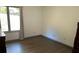 This bedroom features a window and dark wood-look flooring at 5526 Stoneleigh Ct, Stone Mountain, GA 30088