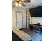 Cozy bedroom featuring a ceiling fan, built-in bookshelf, and an entertainment center with a large-screen TV at 5526 Stoneleigh Ct, Stone Mountain, GA 30088