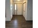 Inviting foyer features neutral paint, a large closet, and beautiful dark wood-look flooring at 5526 Stoneleigh Ct, Stone Mountain, GA 30088