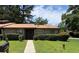 Charming single story home with a brick facade, manicured lawn, and mature trees at 5526 Stoneleigh Ct, Stone Mountain, GA 30088