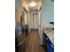 Hallway with laundry, featuring stainless steel fridge at 5526 Stoneleigh Ct, Stone Mountain, GA 30088
