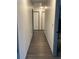 Hallway featuring wood-look flooring and neutral paint at 5526 Stoneleigh Ct, Stone Mountain, GA 30088