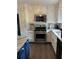 Updated kitchen featuring white cabinetry, stainless steel appliances, and subway tile backsplash at 5526 Stoneleigh Ct, Stone Mountain, GA 30088