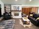 Spacious living room with built-in shelves, a fireplace, and an open layout to a secondary living area at 5526 Stoneleigh Ct, Stone Mountain, GA 30088