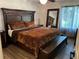This primary bedroom boasts a dark wooden bed frame and an abundance of natural light at 5526 Stoneleigh Ct, Stone Mountain, GA 30088