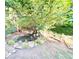 Backyard featuring a pond with waterfall feature surrounded by lush landscaping and mature trees at 665 Roxford Ln, Buford, GA 30518