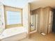 Modern bathroom with soaking tub and tiled shower at 665 Roxford Ln, Buford, GA 30518