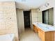 Bathroom showcasing double sinks, a large mirror, neutral tile, and ample cabinet space at 665 Roxford Ln, Buford, GA 30518