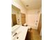 Bright bathroom featuring a shower-tub combo, toilet, and vanity with sink at 665 Roxford Ln, Buford, GA 30518