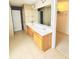 Bright bathroom featuring a double vanity, tile floors, and large mirrors over the sinks at 665 Roxford Ln, Buford, GA 30518