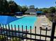 Community pool area with lounge chairs, umbrellas, and a pool house for residents' enjoyment at 665 Roxford Ln, Buford, GA 30518