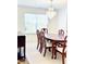 Dining room featuring wood table, chairs, and chandelier at 665 Roxford Ln, Buford, GA 30518