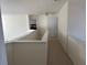 Carpeted hallway with white walls and chandelier at 665 Roxford Ln, Buford, GA 30518
