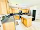 Open kitchen with stainless steel appliances, wood cabinets and granite countertops at 665 Roxford Ln, Buford, GA 30518