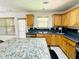 Spacious kitchen with ample natural light and granite-topped island at 665 Roxford Ln, Buford, GA 30518