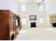 Open-concept living area with tall windows, fireplace, and ceiling fan at 665 Roxford Ln, Buford, GA 30518