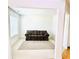 Cozy living room featuring neutral walls, plush carpeting, and a comfortable sofa at 665 Roxford Ln, Buford, GA 30518