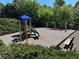 Community playground area with a slide, climbing structures, swings, and benches for parents at 665 Roxford Ln, Buford, GA 30518