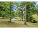 Large backyard with in-ground pool and wooded boundary, perfect for outdoor activities and privacy at 1301 Ficklen Church Way, Canton, GA 30114