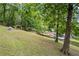 Enjoy the sloping backyard with pool, pergola and mature trees offering a great view and privacy at 1301 Ficklen Church Way, Canton, GA 30114