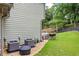 A cozy outdoor area with lush greenery, a patio set, and air conditioning units on the side at 1301 Ficklen Church Way, Canton, GA 30114