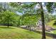 Enjoy this vast backyard with a deck and patio set, surrounded by mature trees and a dark fence at 1301 Ficklen Church Way, Canton, GA 30114