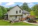 View of the backyard featuring a wooden deck, patio, boat, and landscaping at 1301 Ficklen Church Way, Canton, GA 30114