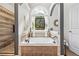 Bright bathroom with a jacuzzi tub under an arched window and a glass-enclosed shower at 1301 Ficklen Church Way, Canton, GA 30114