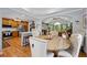 Open concept dining room with hardwood floors, a wooden table and seating for six, and an adjacent modern kitchen at 1301 Ficklen Church Way, Canton, GA 30114
