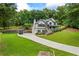 Stately two-story home with three-car garage, lush lawn, and charming front porch, perfect for Gathering gatherings and outdoor entertaining at 1301 Ficklen Church Way, Canton, GA 30114