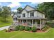 Charming two-story home with inviting front porch, perfect for relaxing and enjoying the beautiful views of the surrounding landscape at 1301 Ficklen Church Way, Canton, GA 30114
