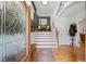 Bright foyer with hardwood floors, elegant staircase, and decorative glass front door at 1301 Ficklen Church Way, Canton, GA 30114