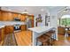 Modern kitchen with stainless steel appliances, custom wood cabinets, marble countertops, and a breakfast bar at 1301 Ficklen Church Way, Canton, GA 30114