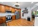 Modern kitchen with stainless steel appliances, custom wood cabinets, and decorative shelving at 1301 Ficklen Church Way, Canton, GA 30114