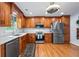 Spacious kitchen with wooden cabinets, stainless steel appliances, and stylish light fixture at 1301 Ficklen Church Way, Canton, GA 30114