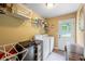 Functional laundry room with washer, dryer, storage shelves, and access to the backyard at 1301 Ficklen Church Way, Canton, GA 30114