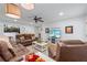 Bright and airy living room boasts hardwood floors, ceiling fan, and cozy brown sofas at 1301 Ficklen Church Way, Canton, GA 30114