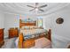Main bedroom featuring a bed, ceiling fan, tray ceilings, and neutral carpeting at 1301 Ficklen Church Way, Canton, GA 30114
