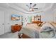 Comfortable main bedroom featuring a ceiling fan, tray ceilings, and a doorway to the en-suite bathroom at 1301 Ficklen Church Way, Canton, GA 30114