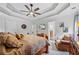 Main bedroom with tray ceiling, en-suite bathroom and sitting chair. Featuring a ceiling fan at 1301 Ficklen Church Way, Canton, GA 30114