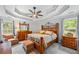 Spacious main bedroom with tray ceiling, ceiling fan, and large windows offering abundant natural light at 1301 Ficklen Church Way, Canton, GA 30114