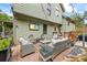 Charming backyard patio with outdoor seating, a fire pit, string lights, and lush greenery for outdoor entertaining at 1301 Ficklen Church Way, Canton, GA 30114