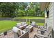 Relax in this outdoor living space, featuring comfortable seating around a fire pit with views of the green backyard at 1301 Ficklen Church Way, Canton, GA 30114