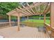Wood deck and pergola with outdoor seating in a fenced backyard with mature trees at 1301 Ficklen Church Way, Canton, GA 30114