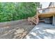 Backyard features wooden fence, trees, patio, deck, and firepit at 3805 Roxwood Park Dr, Buford, GA 30518