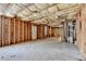 Unfinished basement with exposed wood framing, insulation, and concrete floor. Ready for customization! at 3805 Roxwood Park Dr, Buford, GA 30518