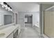Bathroom with double sinks, shower, and a soaking tub with an entrance to the large bedroom at 3805 Roxwood Park Dr, Buford, GA 30518