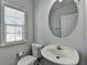 Small bathroom with white sink, toilet, and gray walls at 3805 Roxwood Park Dr, Buford, GA 30518