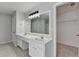 Bathroom boasts double sinks with a large mirror, neutral tile floor, and a view of the walk-in closet at 3805 Roxwood Park Dr, Buford, GA 30518